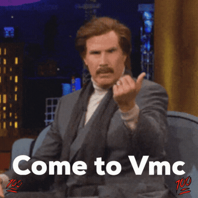 A Man In A Suit And Tie Is Giving The Middle Finger With The Words Come To Vmc Below Him GIF