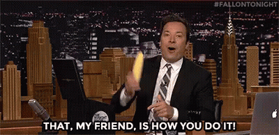 A Man In A Suit And Tie Is Holding A Banana And Saying `` That , My Friend , Is How You Do It ! `` GIF