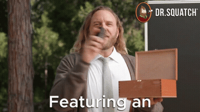 A Man In A Suit And Tie Is Holding A Box That Says Featuring An On It GIF