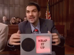 A Man In A Suit And Tie Is Holding A Box That Says Wrap It Up GIF
