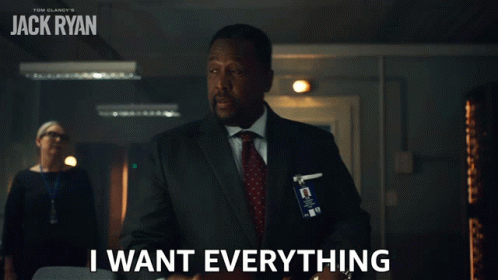 A Man In A Suit And Tie Is Holding A Briefcase And Says " I Want Everything " GIF