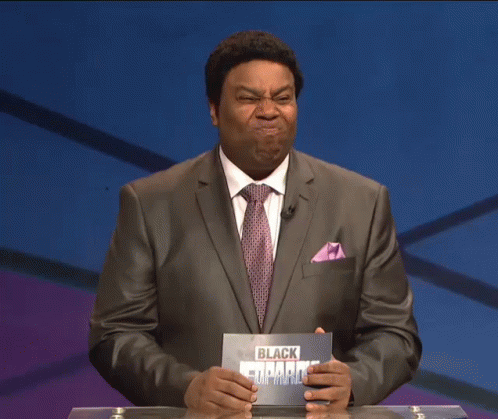 A Man In A Suit And Tie Is Holding A Card That Says Black Leopard GIF