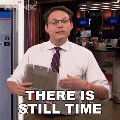 A Man In A Suit And Tie Is Holding A Clipboard And Says There Is Still Time GIF