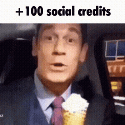 A Man In A Suit And Tie Is Holding A Cone With Whipped Cream . GIF