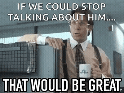 A Man In A Suit And Tie Is Holding A Cup Of Coffee And Talking To Someone . GIF