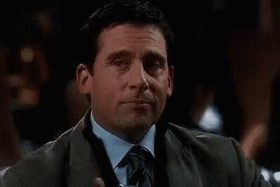 A Man In A Suit And Tie Is Holding A Glass Of Water And Saying De Nada . GIF