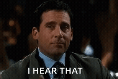 A Man In A Suit And Tie Is Holding A Glass Of Whiskey And Says `` I Hear That '' . GIF