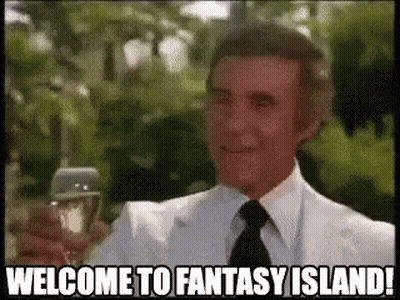 A Man In A Suit And Tie Is Holding A Glass Of Wine And Saying `` Welcome To Fantasy Island '' . GIF
