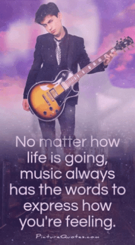 A Man In A Suit And Tie Is Holding A Guitar With A Quote On It GIF
