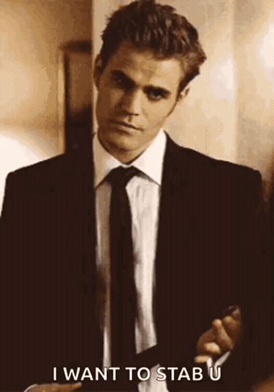 A Man In A Suit And Tie Is Holding A Gun And Saying `` I Want To Stab U '' . GIF
