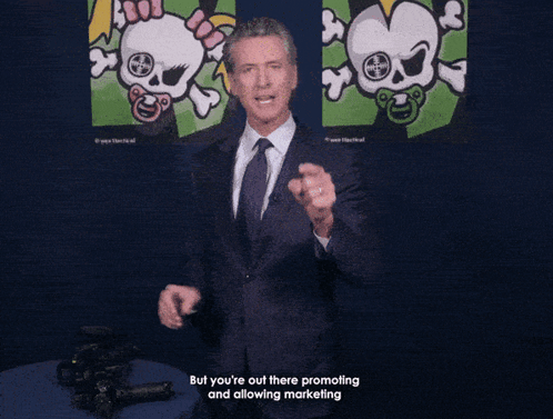 A Man In A Suit And Tie Is Holding A Gun And Says " This Is A Weapon Of War " At The Bottom GIF