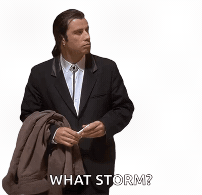 A Man In A Suit And Tie Is Holding A Jacket And Says What Storm GIF