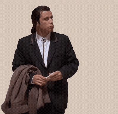 A Man In A Suit And Tie Is Holding A Jacket GIF