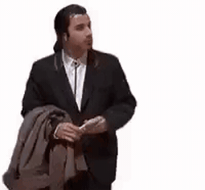 A Man In A Suit And Tie Is Holding A Jacket Over His Shoulder And Smoking A Cigarette . GIF