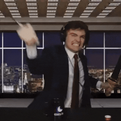 A Man In A Suit And Tie Is Holding A Knife And A Bottle Of Cozy GIF
