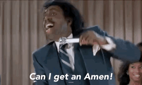 A Man In A Suit And Tie Is Holding A Microphone And Says `` Can I Get An Amen '' . GIF