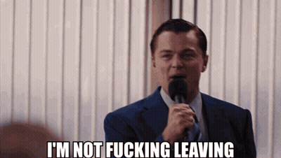 A Man In A Suit And Tie Is Holding A Microphone And Says I 'M Not Fucking Leaving GIF