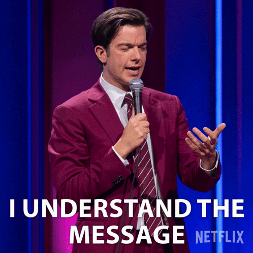 A Man In A Suit And Tie Is Holding A Microphone And Says I Understand The Message Netflix GIF