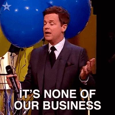 A Man In A Suit And Tie Is Holding A Microphone And Says " It 'S None Of Our Business " GIF