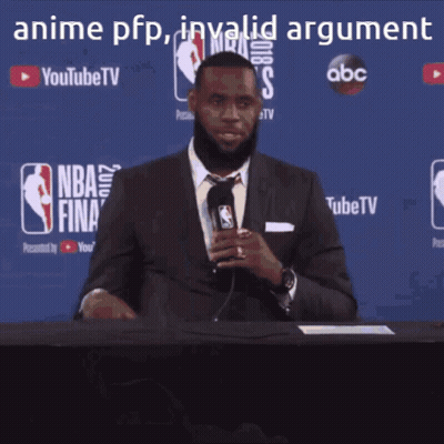 A Man In A Suit And Tie Is Holding A Microphone In Front Of A Nba Finals Sign GIF