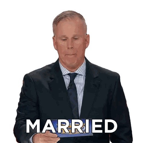 A Man In A Suit And Tie Is Holding A Piece Of Paper With The Word Married On It Sticker
