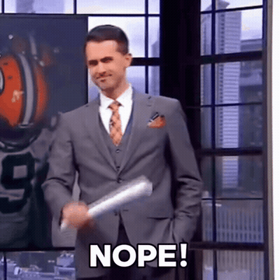 A Man In A Suit And Tie Is Holding A Piece Of Paper With The Word Nope On It GIF
