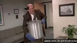 A Man In A Suit And Tie Is Holding A Pot In His Hands . GIF