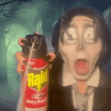 A Man In A Suit And Tie Is Holding A Raid Ant Spray . GIF
