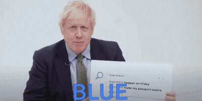 A Man In A Suit And Tie Is Holding A Sign That Says " Blue " GIF