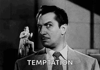 A Man In A Suit And Tie Is Holding A Statue Of A Woman In His Hand . GIF