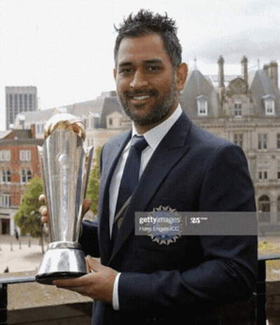 A Man In A Suit And Tie Is Holding A Trophy GIF