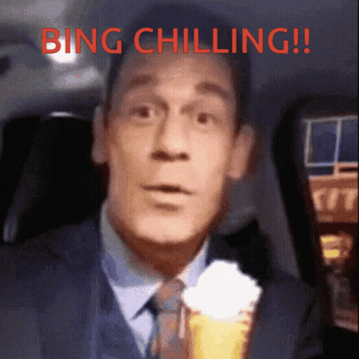 A Man In A Suit And Tie Is Holding An Ice Cream Cone With Whipped Cream And The Words Bing Chilling Above Him GIF