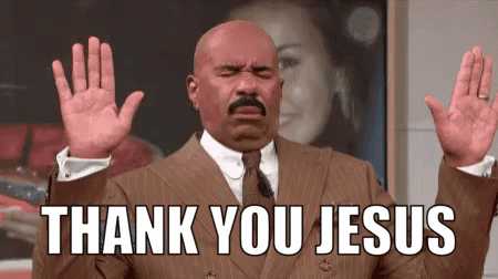 A Man In A Suit And Tie Is Holding His Hands Up In The Air And Saying `` Thank You Jesus '' . GIF