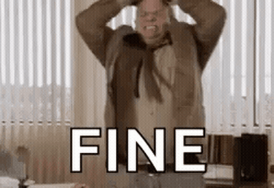 A Man In A Suit And Tie Is Holding His Head In A Room With The Word Fine . GIF