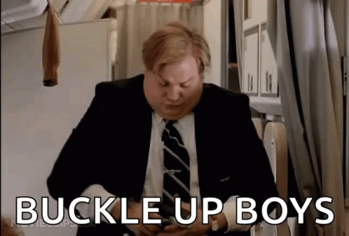 A Man In A Suit And Tie Is Holding His Stomach And Says Buckle Up Boys GIF
