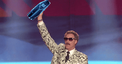 A Man In A Suit And Tie Is Holding Up A Blue Bottle That Says ' Jbl ' On It GIF