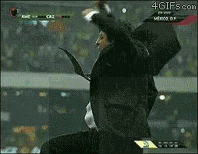 A Man In A Suit And Tie Is Jumping In The Air In Front Of A Screen That Says 4Gifs.com On It GIF