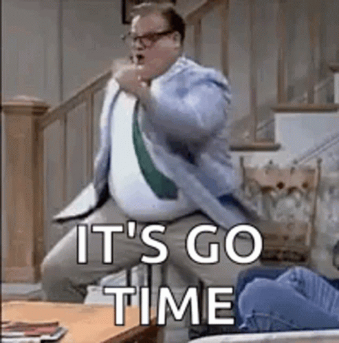 A Man In A Suit And Tie Is Jumping In The Air While Sitting On A Couch . GIF