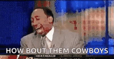 A Man In A Suit And Tie Is Laughing And Says How Bout Them Cowboys . GIF