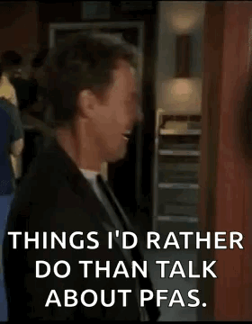 A Man In A Suit And Tie Is Laughing While Talking About Pfas . GIF