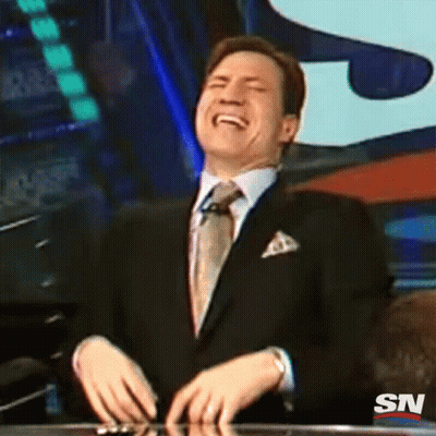 A Man In A Suit And Tie Is Laughing With A Sn Logo In The Background GIF