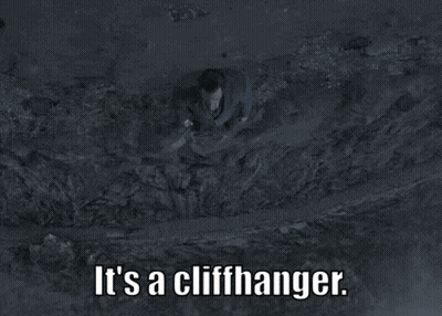 A Man In A Suit And Tie Is Laying In The Dirt With The Words " It 'S A Cliffhanger " Below Him GIF