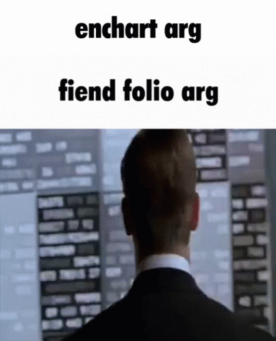 A Man In A Suit And Tie Is Looking At A Computer Screen With The Words Enchart Arg Fiend Folio Arg Written Above Him . GIF