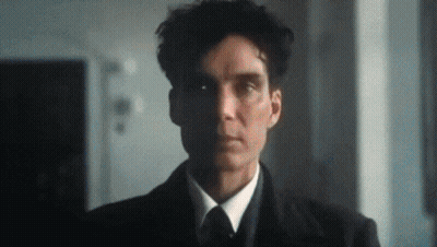 A Man In A Suit And Tie Is Looking At The Camera With A Serious Look On His Face . GIF