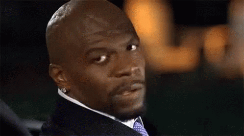 A Man In A Suit And Tie Is Looking At The Camera With A Serious Look On His Face . GIF
