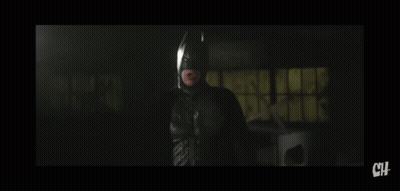 A Man In A Suit And Tie Is Looking At The Camera With The Letters Ch Below Him GIF