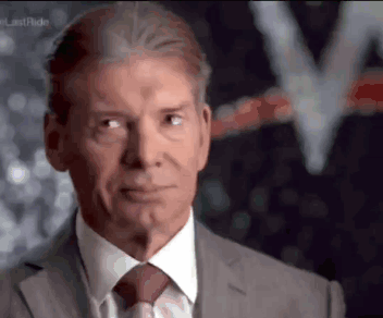 A Man In A Suit And Tie Is Looking To The Side GIF