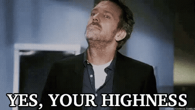 A Man In A Suit And Tie Is Looking Up And Saying Yes , Your Highness . GIF