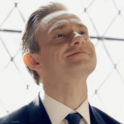 A Man In A Suit And Tie Is Looking Up At The Sky GIF