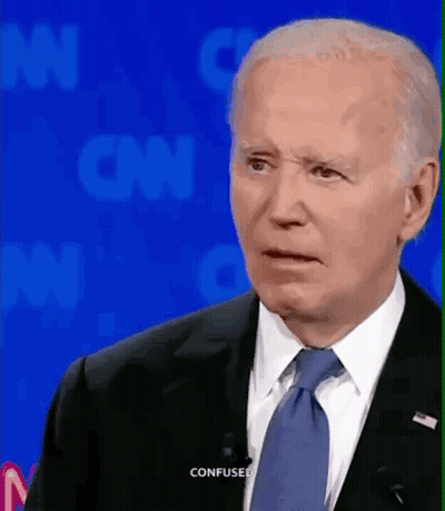 A Man In A Suit And Tie Is Making A Confused Face While Talking On Cnn GIF